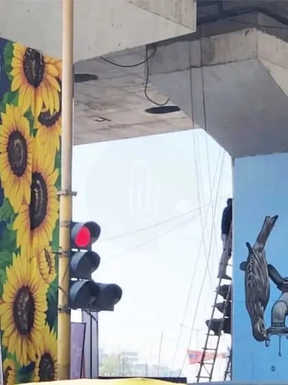 Another view of the pillar project, showing the 3D snake, sunflower, and a bird mural in progress. This highlights the diversity of styles within a single project.