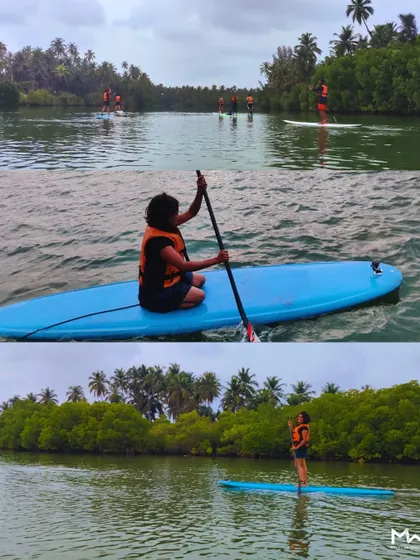 More scenes from a stand-up paddle session in Mulki, with the team spread out across the water, enjoying the serene environment.