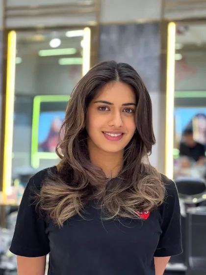 A happy client with her new balayage. The face-framing highlights and soft waves create a beautiful, flattering style.