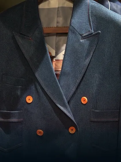 Live life with the kind of style that feels like second nature. This image focuses on a double-breasted jacket, highlighting its sharp lapels and bold button choice.