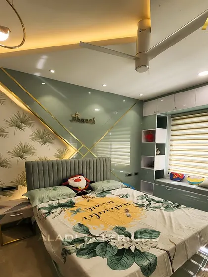 A contemporary bedroom design for a child or teen, featuring a soft green color palette and a stylish headboard with a personalized nameplate. A cozy window seat with built-in storage adds a functional and charming element.