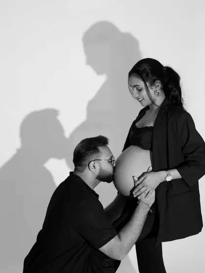 Playing with light and shadow. This creative black and white portrait uses the couple's shadow to add depth and artistry to a tender moment.