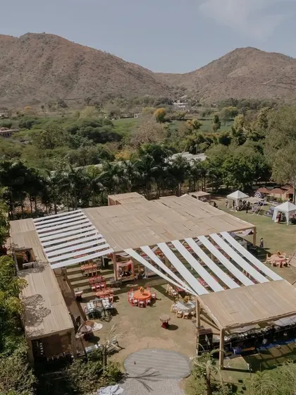 Another aerial shot of the 'Rajasthani Folklore' Mehendi, capturing the entire layout against the stunning mountain backdrop.