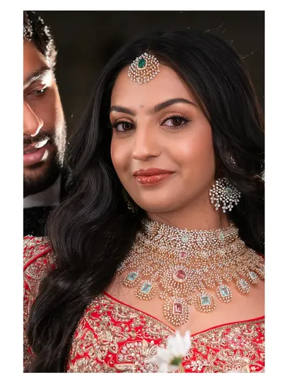 A lovely couple shot from Likitha's reception. My makeup ensures the bride looks stunning from every angle, even in candid moments with her partner.