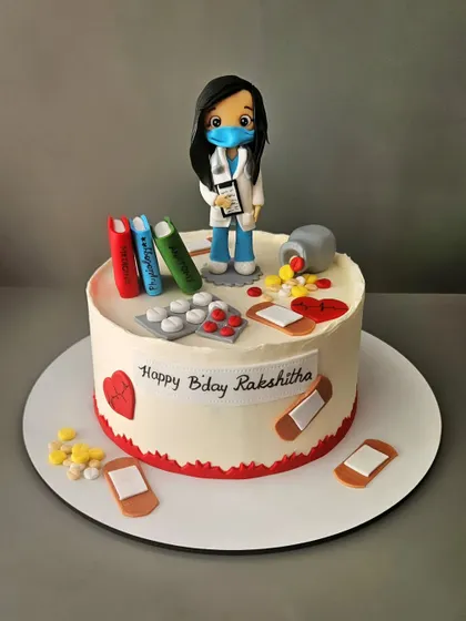 A cake for a Doc! This red velvet cake for Rakshitha's birthday is decorated with all things medical, from pills and bandaids to a custom doctor figurine.