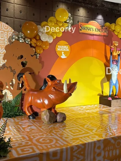 A dynamic angle of the stage, featuring Mufasa, Pumbaa, and Timon props amidst jungle foliage.