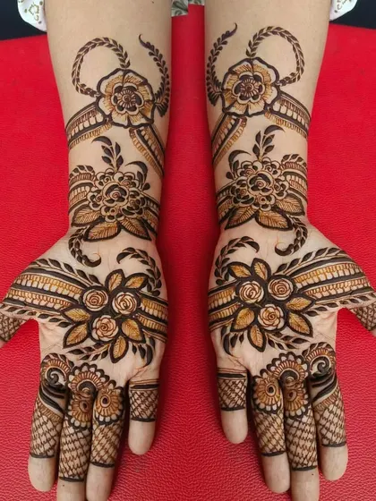 This design showcases a beautiful mix of floral and ribbon-like patterns flowing across both hands. The symmetry and shading give the flowers a very realistic and elegant look.