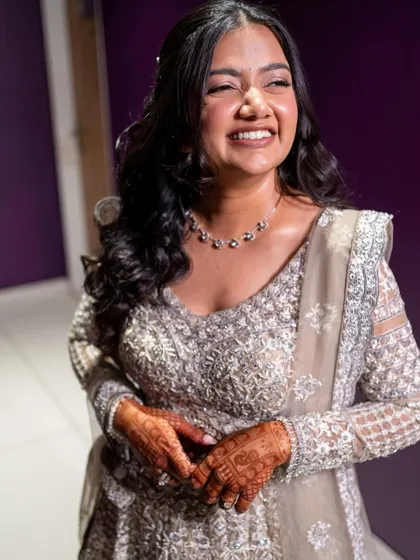 The bride's happy and confident smile shows how much she loved her sangeet look. The makeup is light, comfortable, and perfectly matches her personality.