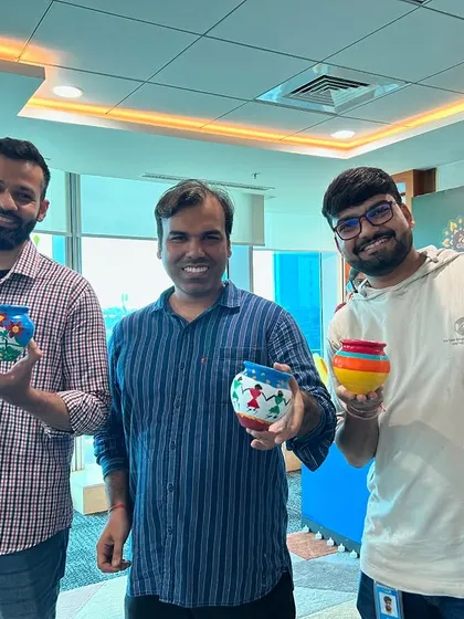 Three proud creators with their colorful, finished pots. These make for a wonderful, handmade souvenir from a fun team event.