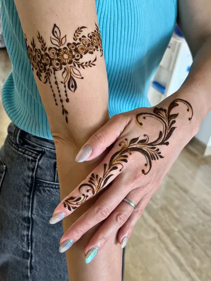 Life is too short for boring nails, so spice it up with some mehndi. This is a perfect example of a modern, stylish design with an arm band and a finger vine.