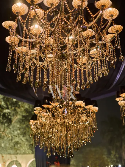 A detail shot of the magnificent crystal chandeliers used throughout our events. Their intricate design and warm light are essential to creating the luxurious, dreamy atmosphere we are known for.