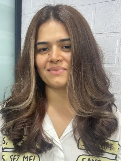 A fresh and modern look for this client, featuring face-framing highlights and a layered cut that adds movement and style.