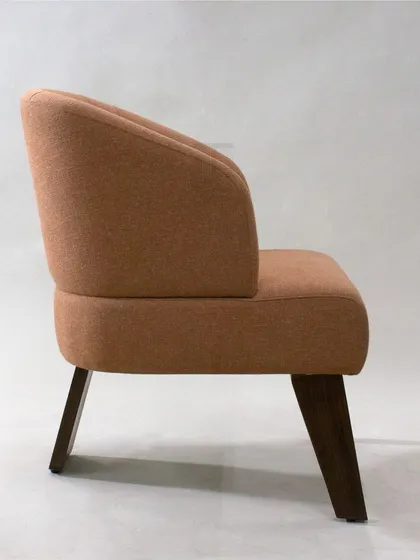 The side profile reveals the chair's comfortable recline and elegant, minimalist form.