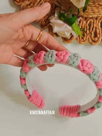 The finished macrame rose flower hairband in pink and green. This beautiful accessory is great as a return gift or party favor.