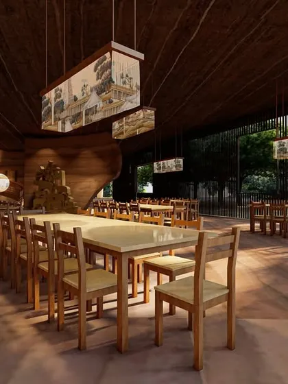 The dining area within the Elephant Pavilion is designed for communal gathering. The open layout, simple timber furniture, and custom hanging lights create a functional space that feels connected to the surrounding forest, with materials that are honest and durable.