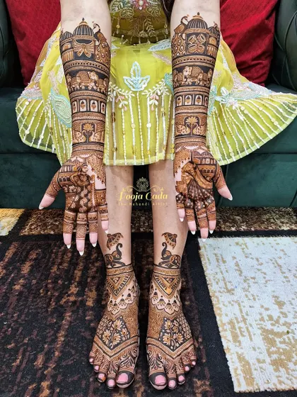 A full bridal set for an NRI bride from the US, with royal elephant motifs on the feet to match the grandeur of the hand designs.