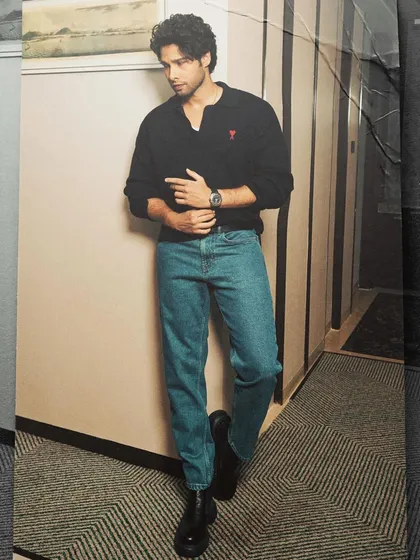Siddhant Chaturvedi in a classic casual look. The Ami Paris sweater and Hugo Boss jeans are timeless pieces that create a polished, off-duty style.