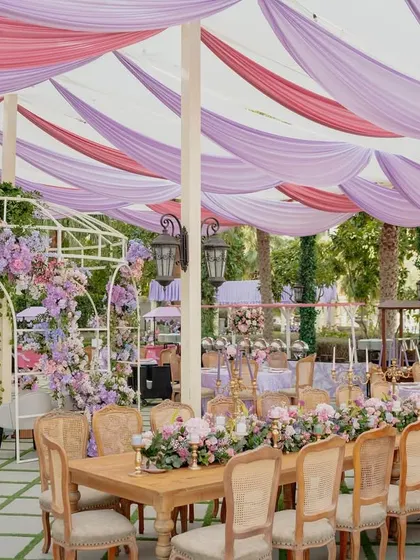 Another view of the elegant seating, where long wooden tables are paired with classic chairs and lush floral centerpieces, perfect for a sophisticated celebration.