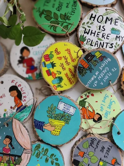 A variety of our hand-painted wooden slice ornaments. Each one features a unique illustration and quote, perfect for gifting or hanging around the house to spread a little joy.
