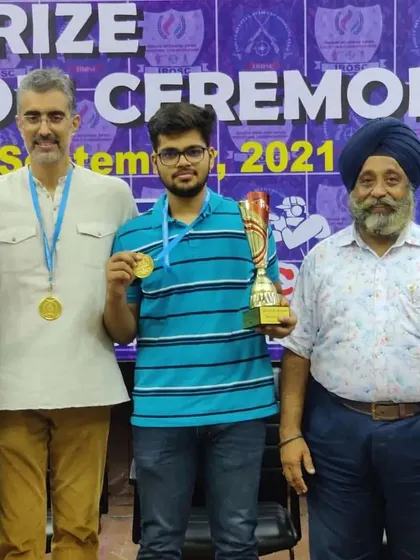 Celebrating with a champion from the 10m Air Pistol event who secured a gold medal and the champion's trophy at the IROSC 2021.