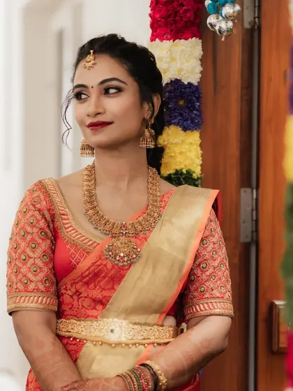 For Dr. Pooja's bangle ceremony, we went for a classic and elegant look. The makeup features a defined eye and a bold red lip, perfectly matching her beautiful silk saree and traditional gold jewellery.