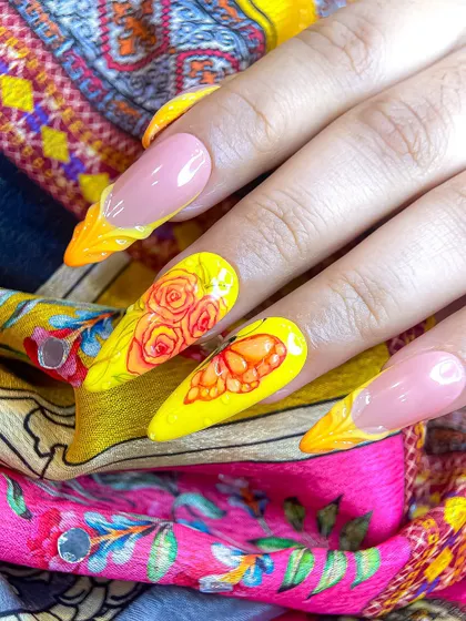 The full set of the yellow Navratri nails, demonstrating how to combine detailed art on some nails with creative French tips on others for a balanced look.