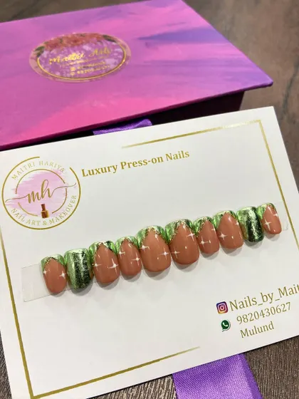 A custom press-on set with a unique green and brown design, accented with glitter. This shows the range of color combinations I can work with.