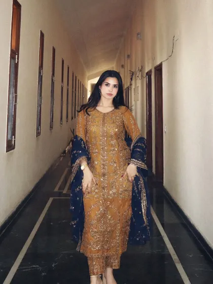 A full-length view of the elegant Asim Jofa Pakistani-style suit, perfect for a wedding guest look.