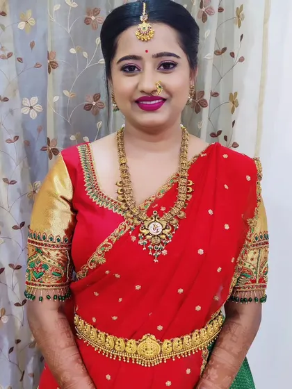 A lovely client ready for a function in a red and green langa voni. The makeup is bright and festive with a bold pink lip.