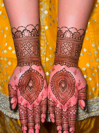 This design combines a central heart-shaped pattern with a detailed wrist cuff. It's a beautiful and symbolic choice for guests at a wedding or engagement party.