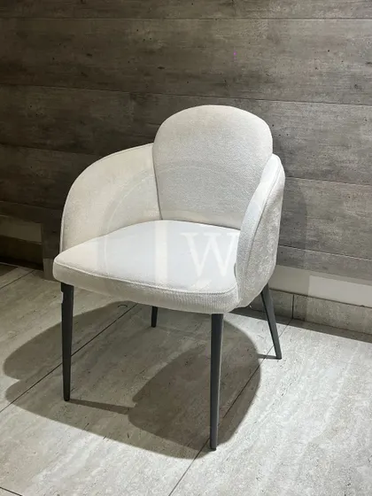 A simple yet elegant dining chair in a light, textured fabric. Its minimalist form and clean lines make it a perfect match for a variety of dining table styles.