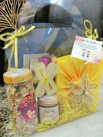 A full view of the yellow-themed transparent Rakhi gift bag.