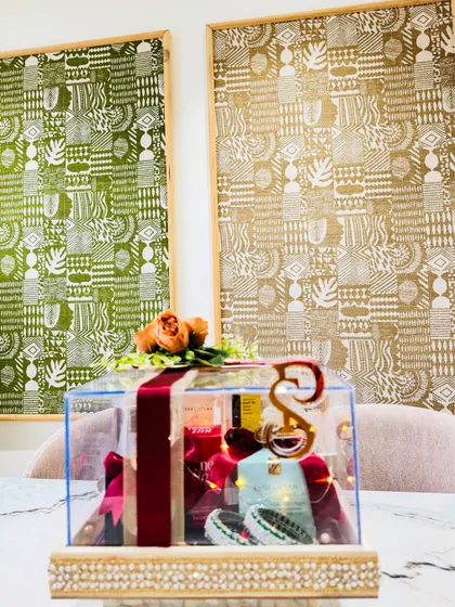 A luxurious acrylic box curated with the finest makeup must-haves from brands like Estée Lauder and Bobbi Brown, wrapped in rich velvet ribbons.