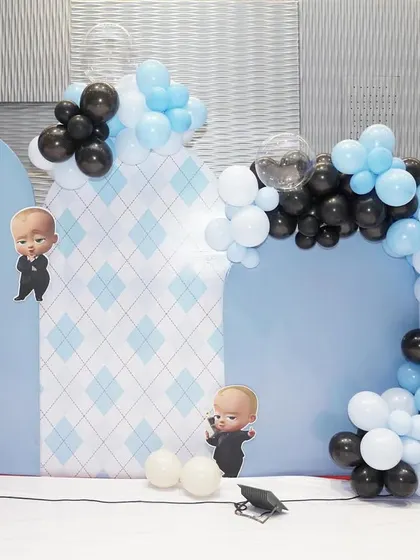 A photo booth area for the Boss Baby party, with themed panels and balloon garlands.