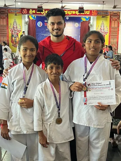 Posing with a group of my medal-winning students. Their collective success builds a strong team spirit.