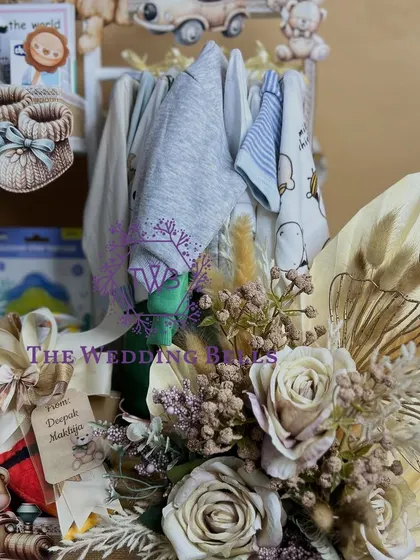 A detailed shot of the floral arrangement and personalized tag on our baby shower hamper. Every element is crafted with love.