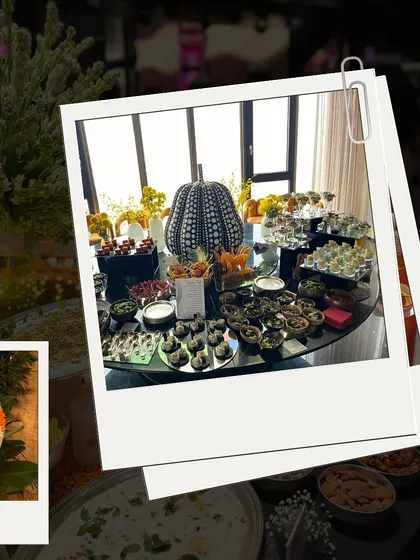 A glimpse of a stylish wedding event setup. The table features a modern, artistic pumpkin centerpiece and a spread of dark, elegant appetizers, showing our ability to match any wedding theme.
