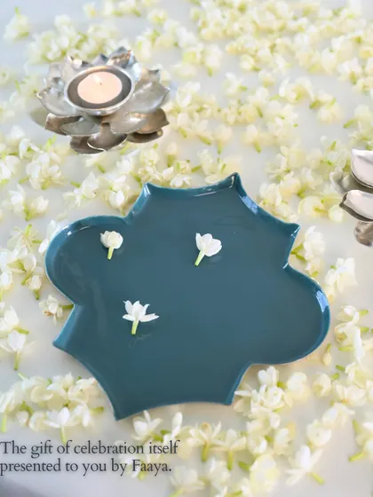 The gift of celebration itself. Our Aakar tray in a deep teal, adorned with just a few fresh jasmine flowers, shows that sometimes the simplest styling is the most beautiful.