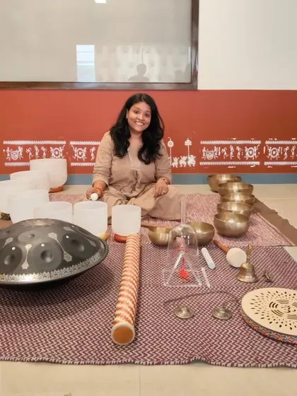 A student from our March batch, surrounded by the tools of her new practice. These graduates are already out in the world hosting powerful sound bath sessions.
