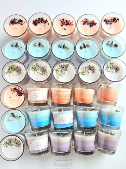 The full set of 35 layered candles, displaying the beautiful ombre effects and botanical toppings for the wedding return gifts.