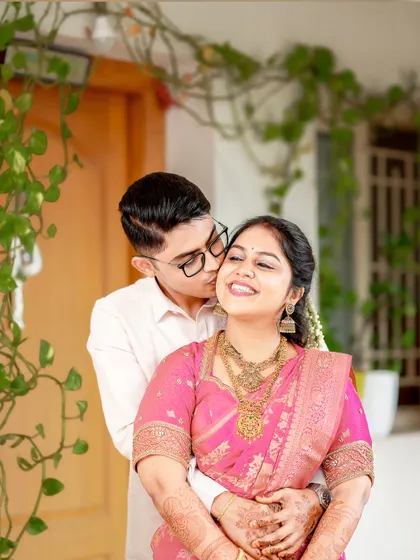 It's the in-between glances and gentle gestures that tell the real story. This candid shot of a groom's affectionate kiss during their Coimbatore wedding captures the pure, unscripted love between the couple.