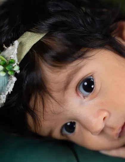 Those wide, curious eyes are just captivating. This is a beautiful example of an "awake" shot during a newborn session, capturing a moment of quiet observation.
