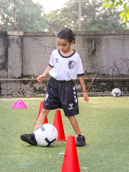 A close-up of footwork during a cone drill. Mastering these foundational movements is crucial for developing the confidence to take on opponents in a match.