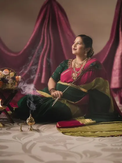In this moment, serenity meets tradition. A mother-to-be, glowing with grace, surrounded by the warmth and light of diyas.