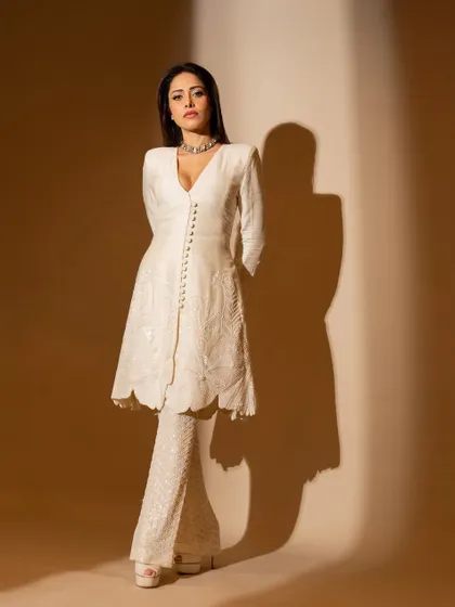 Another view of the ivory suit, showing its clean lines and classic silhouette. A perfect choice for a formal event.