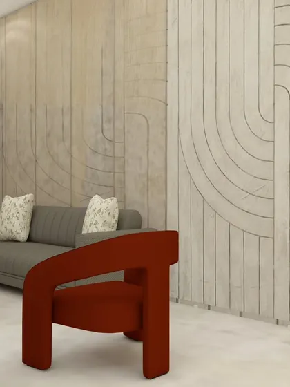 A close-up of the wall paneling detail in our ATS Nobility project. The curved grooves add a layer of texture and artistry to the living room, complemented by the bold, modern armchair in a contrasting rust color.