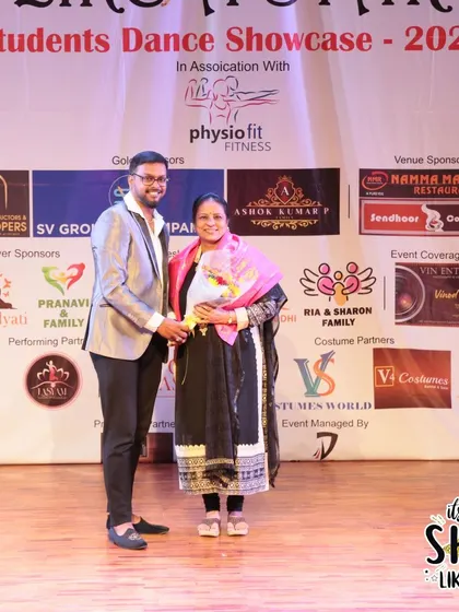 Presenting flowers and an award to a special guest at our showcase.