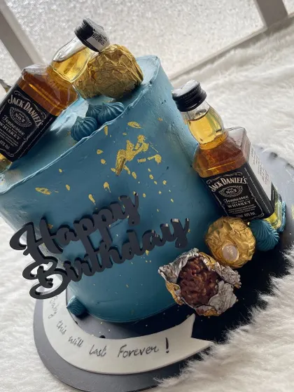 Another cool liquor-themed cake. This one is a striking blue, topped with mini Jack Daniel's bottles and Ferrero Rocher chocolates.