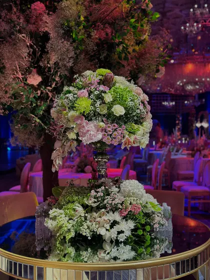An unapologetic flush of sparkle and glitter. This close-up of a floral centerpiece on a mirrored table reflects the dazzling ballroom, filled with light and luxury to celebrate two special souls.