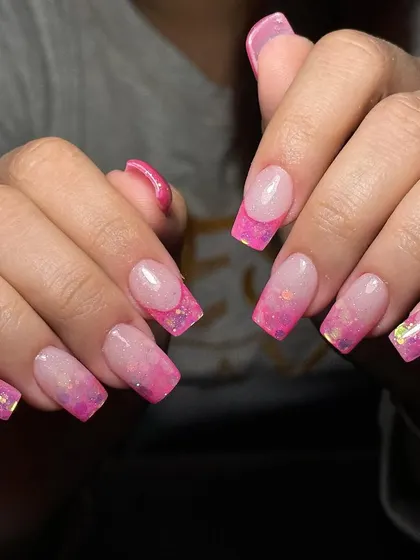 In our courses, you'll learn advanced techniques like this inbuilt acrylic design. This method involves encapsulating glitter and color within the acrylic itself to create a sparkling pink ombre French tip that has depth and dimension.